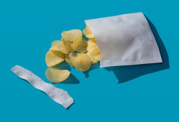 Potato chips in plastic bag on blue background,