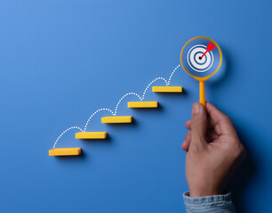 Stairs made by wooden blocks with the target icon at the top. goals concept, achievement or business progress goal concept.