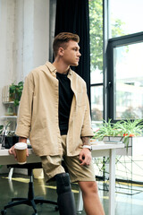 A young professional with a prosthetic leg engages thoughtfully in a vibrant office setting.