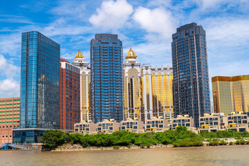 The high skyscraper in the Taipa Island new city that full of the new modern colorful business buildings, with sun light flare, Macao, China.