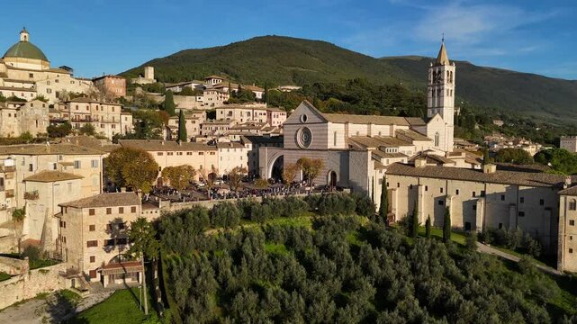 Basilica Santa Chiara in the historic center of Assisi, Perugia, Umbria, Italy.
Aerial view of the Basilica Santa Chiara in Assisi, with tourists queuing in front of the entrance.