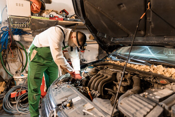 Automotive Technician Performing Engine Repairs in a Garage Setting