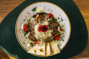 Closeup of delicious steak salad with bread and vegetables.