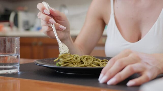Vegetarian Woman Eats Spaghetti With DOP Basil Pesto On Plate