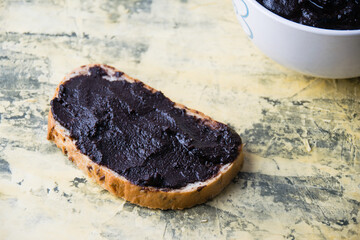 A tasty and nutritious snack of white bread with chocolate paste on a light background. Concept of calories and junk food.