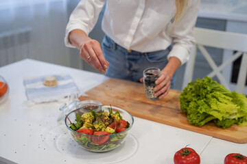 Cooking concept. Woman hands making healthy dinner, cutting vegetables on chopping board, kitchen interior, closeup