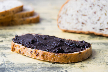 A tasty and nutritious snack of white bread with chocolate paste on a light background. Concept of calories and junk food.