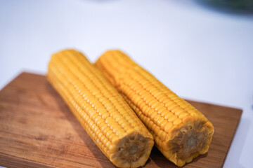 Two ears of boiled corn on the table. Healthy diet.