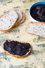 Flatlay, a delicious snack of white bread with chocolate paste on a light background. Concept of calories and junk food.