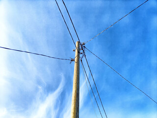 Old pole with wires against the sky. Electric transmission line. Eco-friendly energy