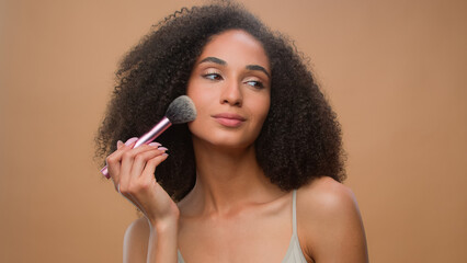 African American woman applying powder make-up natural beauty clean soft moisturized hydrated skin...