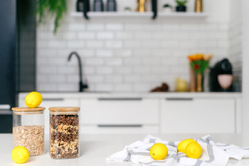 Fresh lemons and jars of granola on a modern kitchen countertop