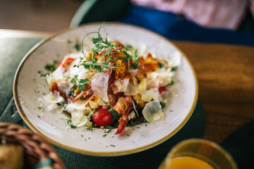 Caesar salad with cherry tomato, bread and cheese.