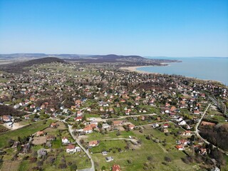 A photo of a small town with a lake in the background