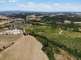 A photo of a large field with a lot of trees and a building