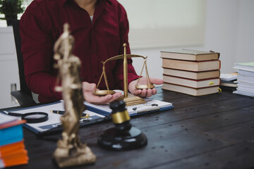 An Asian male lawyer meticulously reviews legal documents, ensuring accuracy and compliance for an upcoming court case. He highlights key points and prepares strategies to effectively