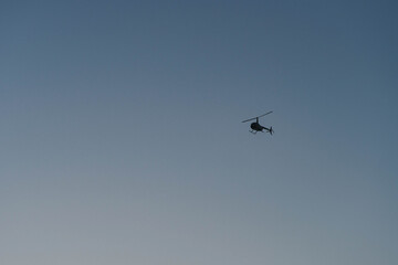 Helicopter on a clear blue gradient sky