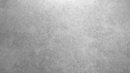 Gray wall with gray texture background and top lighting. The wall is made of concrete and has a rough texture.