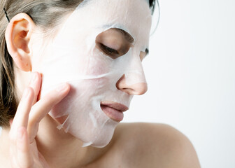 Woman’s face wearing a collagen sheet mask