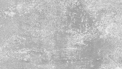 A grey wall with a rough texture. The wall is covered in white paint and has a grainy appearance