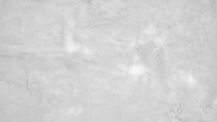 Naklejka premium A grey wall with a rough texture. The wall is covered in white paint and has a grainy appearance
