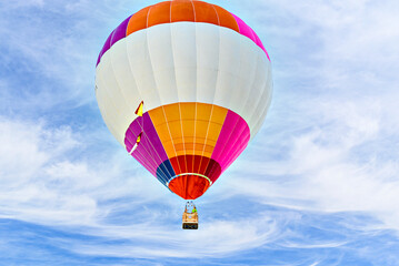 Naklejka premium Colorful hot air balloon flying over blue sky with white clouds 