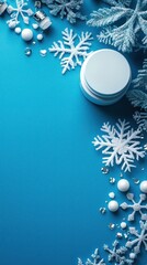 Winter beauty flat lay with snowflakes and cream jar on a blue background.