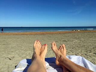 Field with yellow-red tulips, on the island of Mainau
Two pairs of bare feet on the beach on a deck chair with a view of the sea in Ibiza