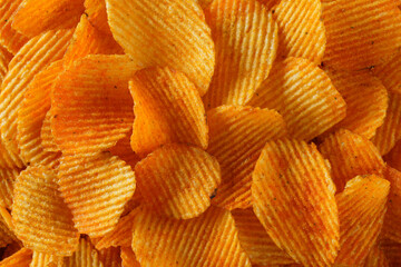 background ribbed potato chips with seasoning, food background, top view