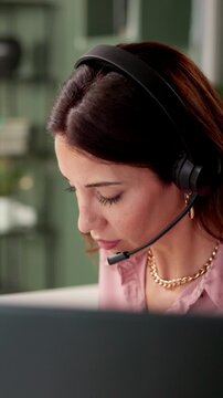 Woman, mic and headset in call center at night with computer, reading and contact us for legal advice. Paralegal, consultant or agent with voip tech, headphone and support with talking at workplace