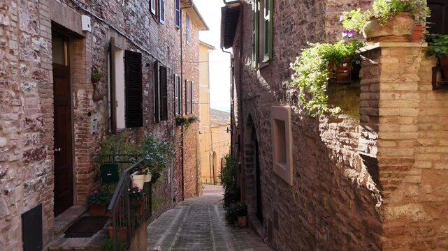 The alleys of the historic center of Spello, a medieval town in Umbria, Italy.
The narrow streets of the center of Spello paved with terracotta bricks.