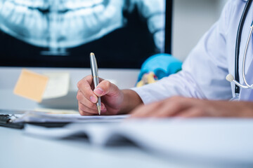 Dentist explaining tooth X-Rays to patient or consultation and recommend guidelines for orthodontics Dentist giving advice on patient's condition. A doctor is diagnose for mouth injury or pain result