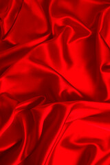 Red silk or satin luxury fabric texture can use as abstract background. Top view.