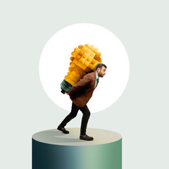 A man carries a large light bulb made from blocks.