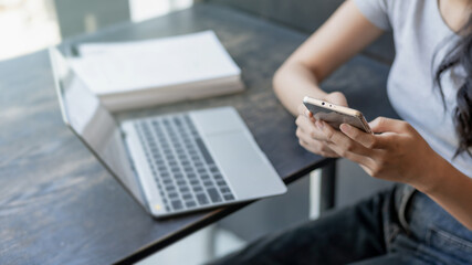 Woman use smart phone at workplace for online web internet search