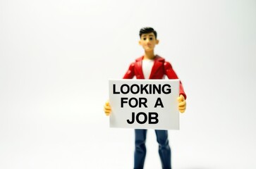 Fototapeta premium toy man holding a sign with the text (I'm looking for a job)