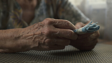 Elderly woman hands holding a handkerchief. Close-up.