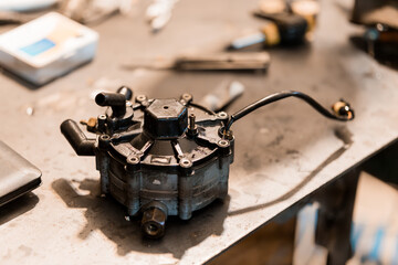 Intricate Fuel Pump Component on Workshop Table