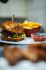 A delicious burger served with a side of fries and ketchup. Perfect for burger joints and promotional materials, appealing to fans of classic American fast food.