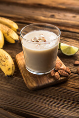 Healthy breakfast. Banana almond smoothie with cinnamon and oat flakes and coconut milk in glass...