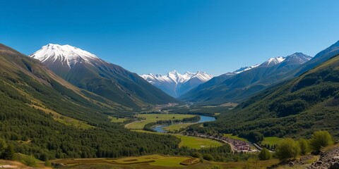 Fototapeta premium A stunning panoramic view of a lush green valley with a winding river and snow-capped mountains in the background, under a clear blue sky, environment, peaceful