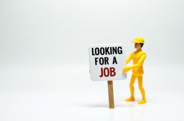 toy man holding a sign with the text (I'm looking for a job)