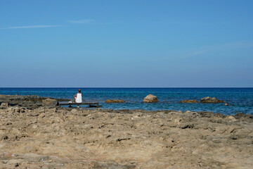 Girl on a Wooden Dock Gazing at the Turquoise Sea Horizon