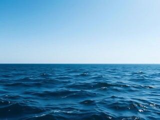 Obraz premium A vast expanse of deep blue water stretching to the horizon with gentle waves and a clear sky above, creating a sense of tranquility and freedom, freedom, nature