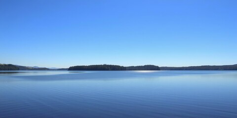 Fototapeta premium A serene lake reflecting a clear blue sky on a calm day, zen, water