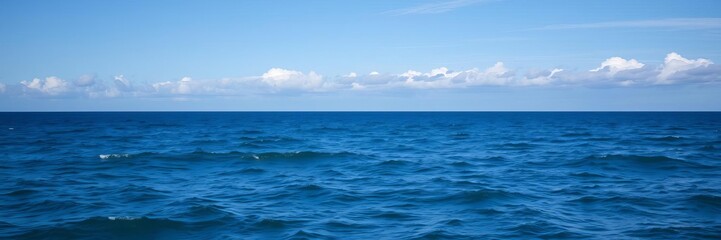 Obraz premium A scenic view of the vast ocean with clear blue water and a cloudy sky overhead, representing tranquility and serenity, waves, horizon
