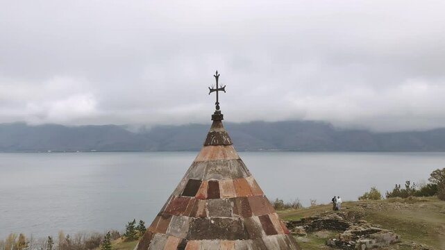 Aerial view cross and cupola over Sevanavank monastic complex. Peninsula at the northwestern shore of Lake Sevan in the Gegharkunik Province of Armenia. Popular travel sightseeing attraction