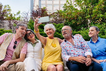 Group of senior friends meeting outdoors in the city and having fun - Cheerful old people bonding together, concepts about elderly, quality of life and aging lifestyle