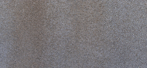 Background of compacted gray gravel wall with uniform texture