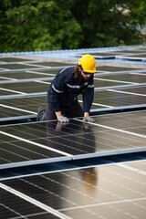 Male engineer checking solar cell  or photovoltaic cell by electronic device installed on the roof...